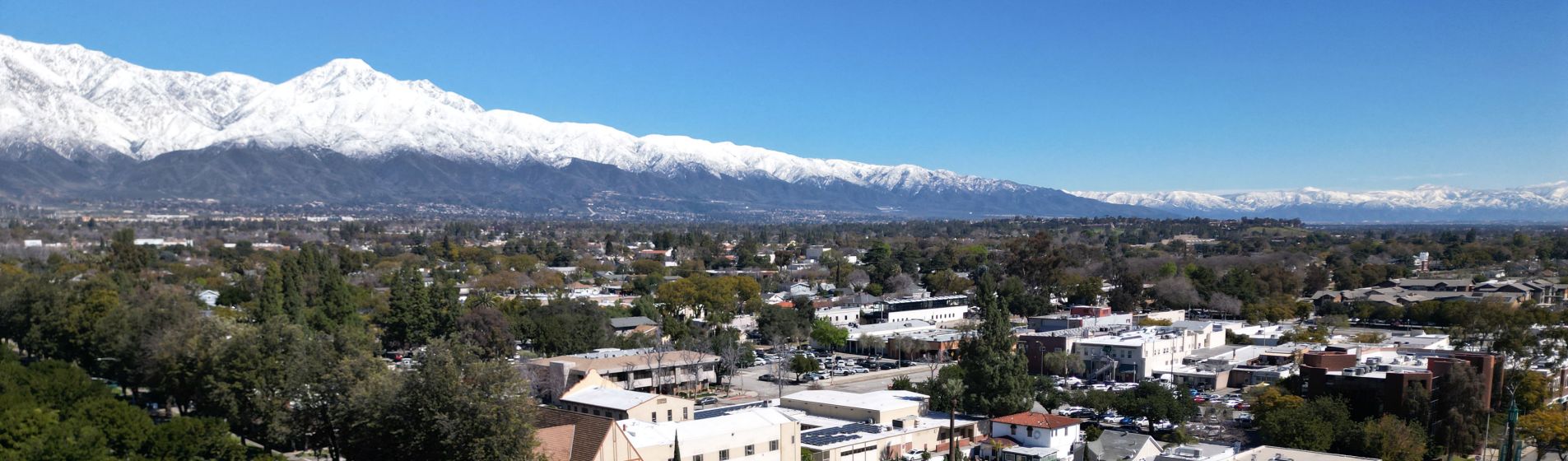 Aerial view of Historic downtown Upland with blue sky and snow-capped mountains
