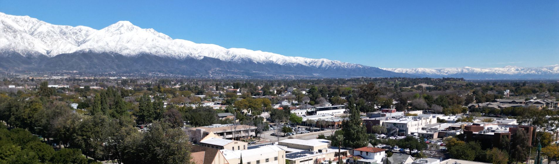Aerial view of Historic downtown Upland with blue sky and snow-capped mountains